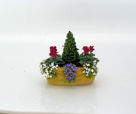 Red Geranium Planter with Rockery and Conifer